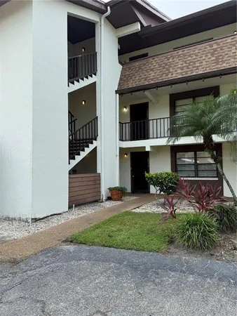 a view of a house with a yard and a large window