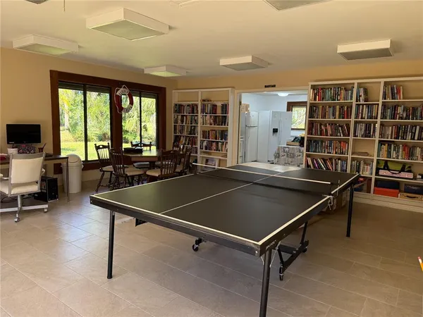 a room with pool table and windows