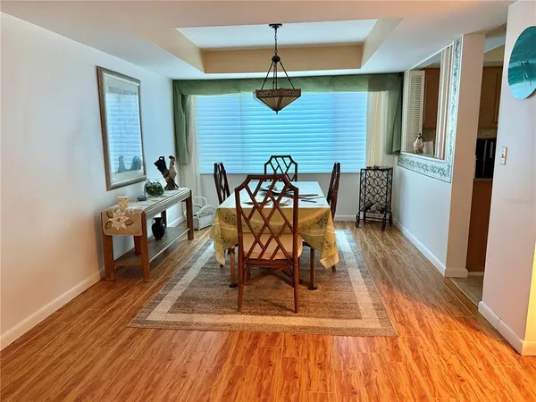 a dining room with furniture and wooden floor