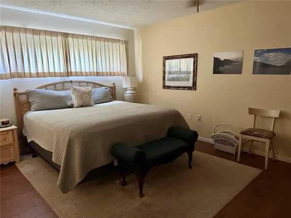 a bedroom with a bed and chair