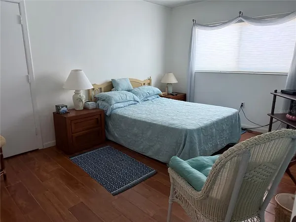 a bedroom with bed and window