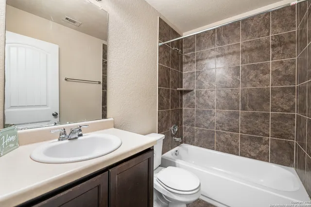 a bathroom with a sink a toilet and bathtub