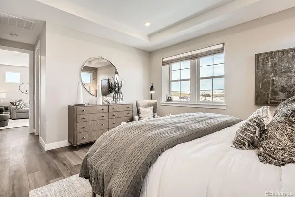 a bedroom with a bed and a window with the outer view