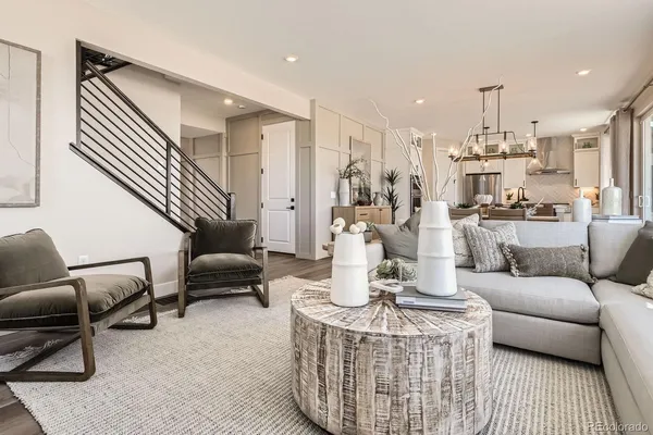 a living room with furniture and a chandelier