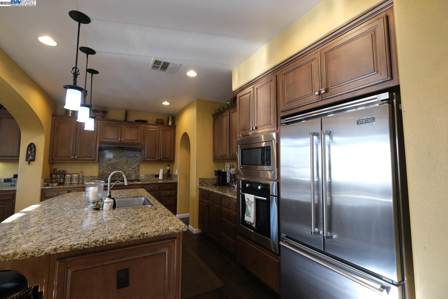 3252 Carpenter Way San Ramon, CA 94582 - Photo 16 of 58 a kitchen with stainless steel appliances granite countertop a sink a stove and a refrigerator