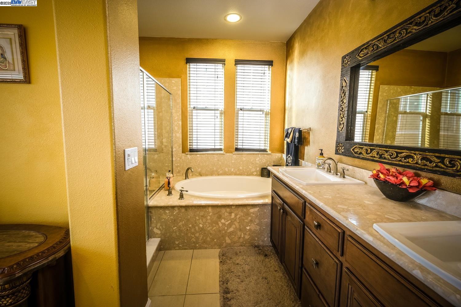 3252 Carpenter Way San Ramon, CA 94582 - Photo 38 of 58 a spacious bathroom with a granite countertop tub sink and mirror