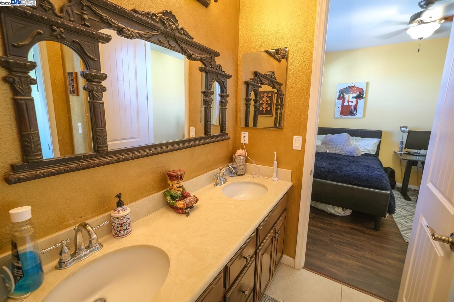 3252 Carpenter Way San Ramon, CA 94582 - Photo 49 of 58 a bathroom with a granite countertop sink and a mirror