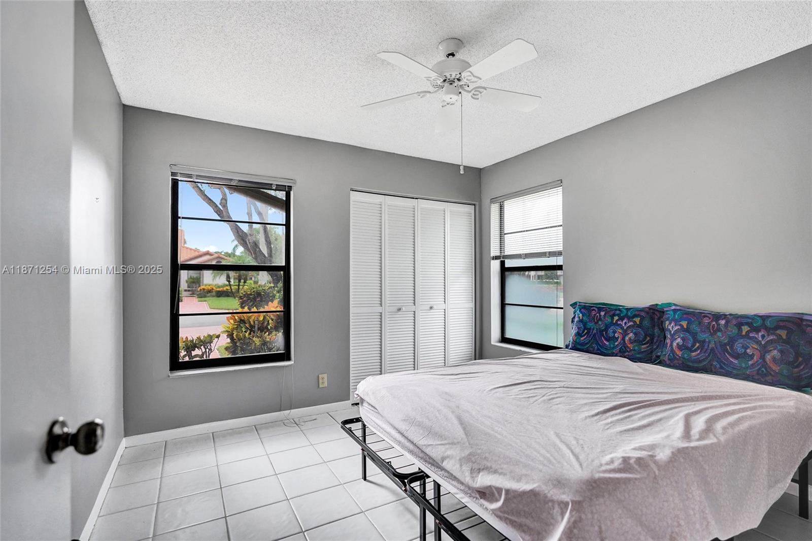 6139 Sunrise Pointe Court, Unit A Delray Beach, FL 33484 - Photo 13 of 41 a bedroom with a bed and a window