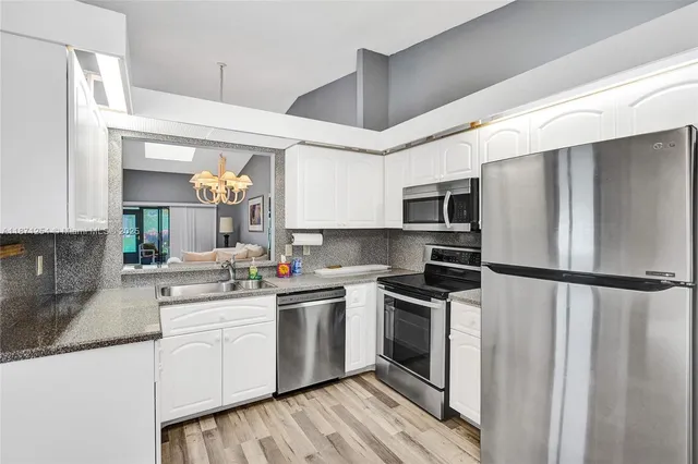 a view of a hallway with living room and furniture