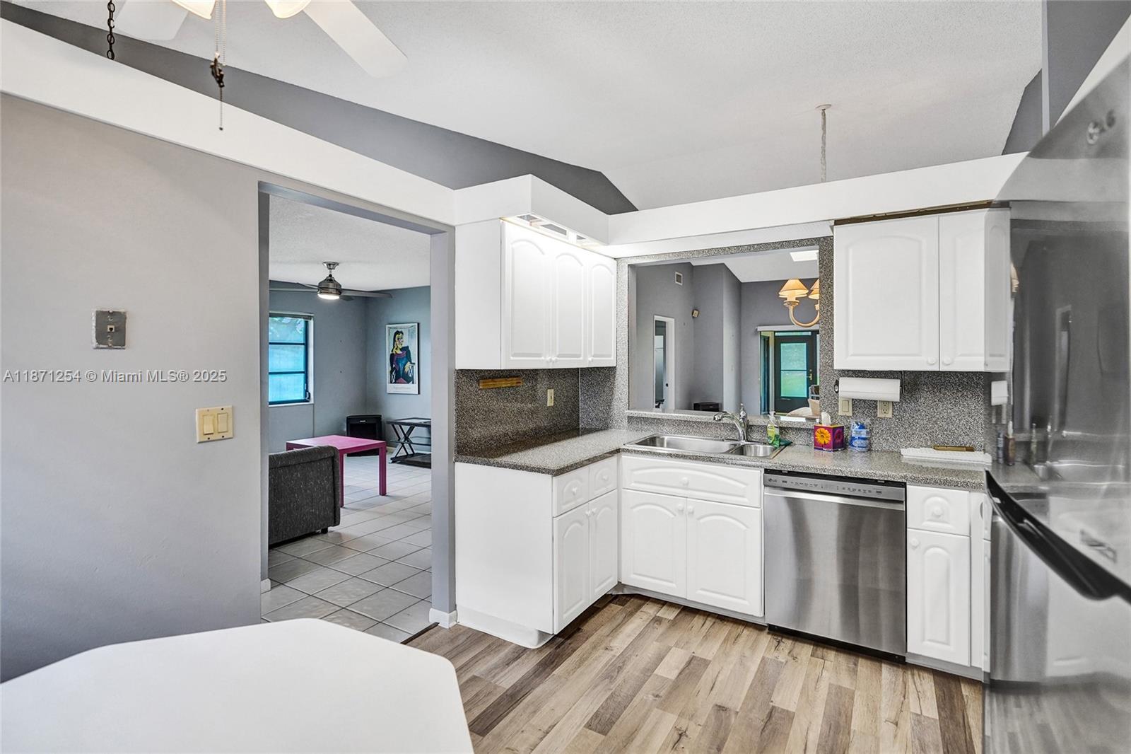 6139 Sunrise Pointe Court, Unit A Delray Beach, FL 33484 - Photo 17 of 41 a kitchen with a sink cabinets and wooden floor