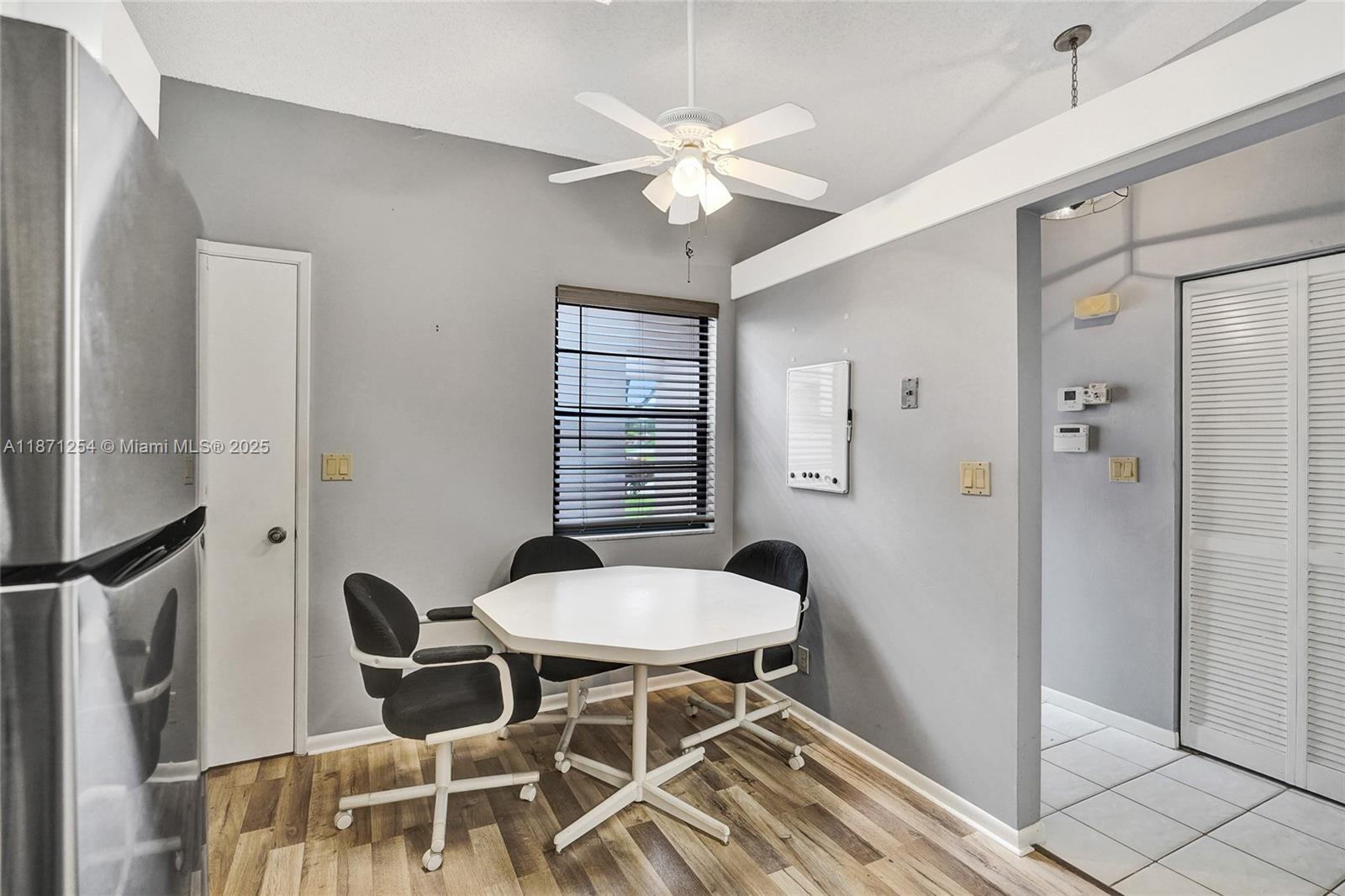 6139 Sunrise Pointe Court, Unit A Delray Beach, FL 33484 - Photo 18 of 41 a view of a dining room with furniture and a chandelier fan