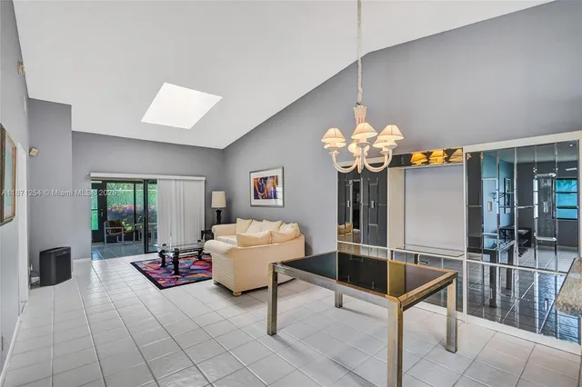 a living room with furniture a flat screen tv and a window