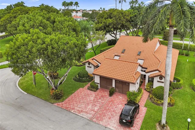 an aerial view of a house with a yard and potted plants