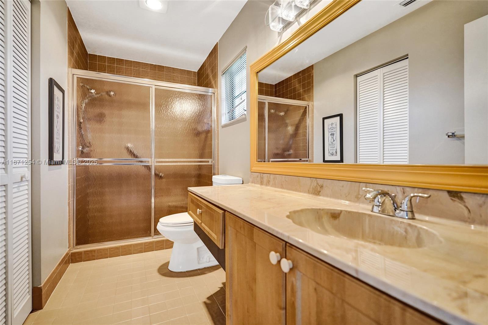 6139 Sunrise Pointe Court, Unit A Delray Beach, FL 33484 - Photo 26 of 41 a bathroom with a sink a toilet and shower