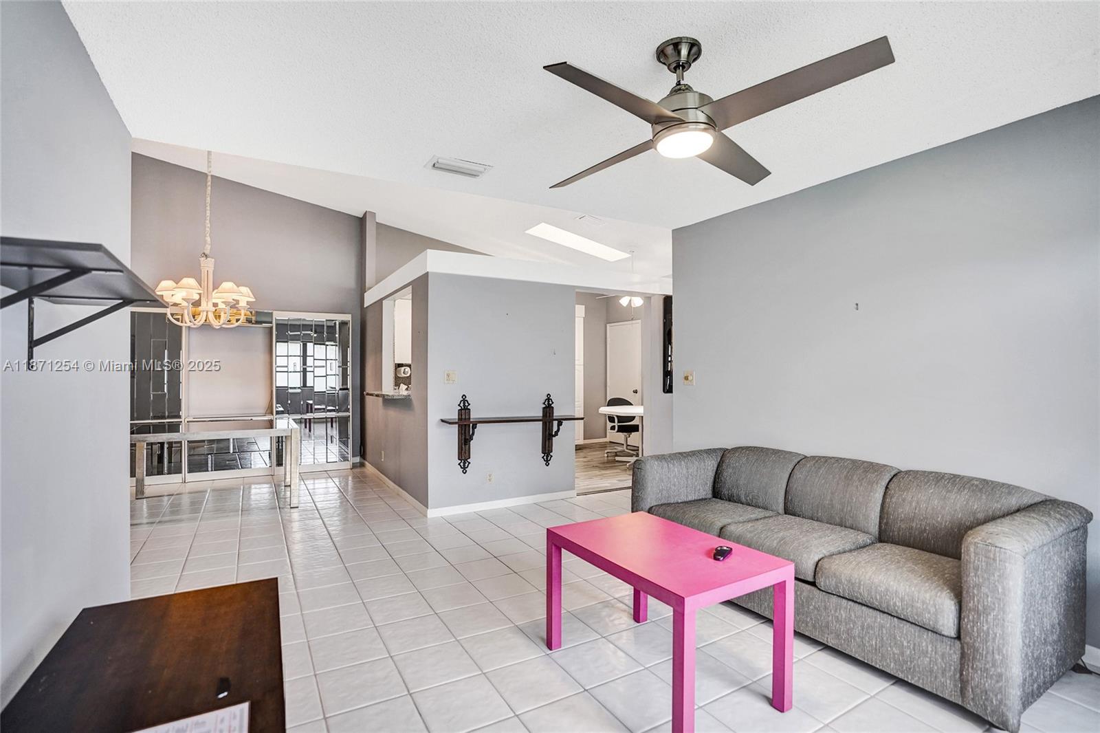 6139 Sunrise Pointe Court, Unit A Delray Beach, FL 33484 - Photo 35 of 41 a living room with furniture and a table