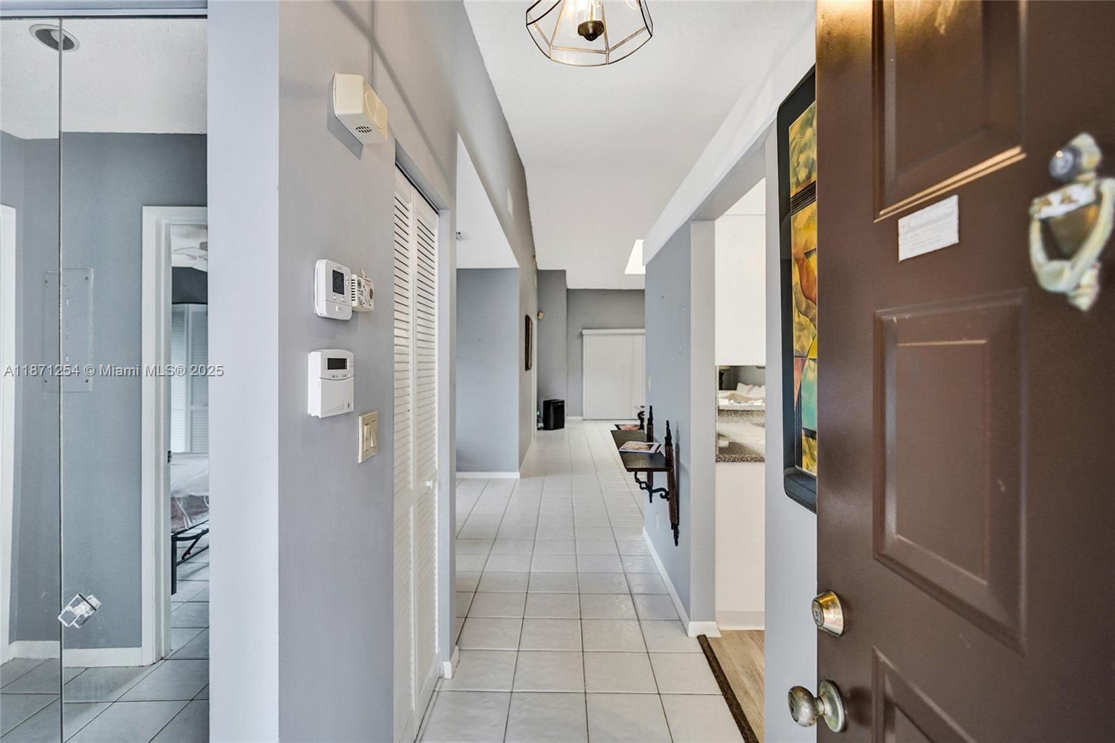 6139 Sunrise Pointe Court, Unit A Delray Beach, FL 33484 - Photo 10 of 41 a view of a hallway with a livingroom and furniture