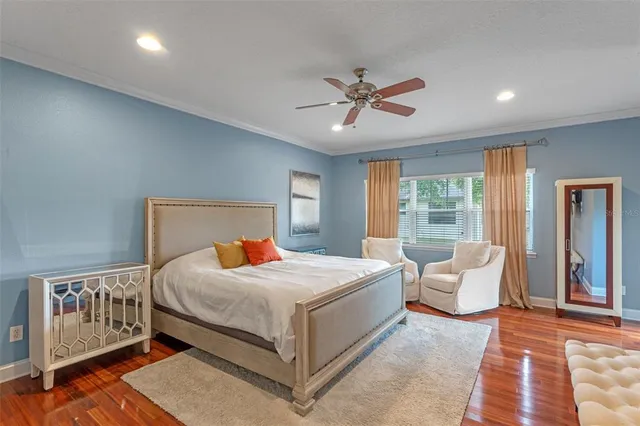 a bedroom with a bed couch and window