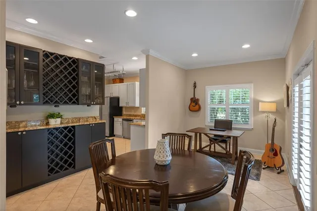 a dining room with furniture a window and wooden floor