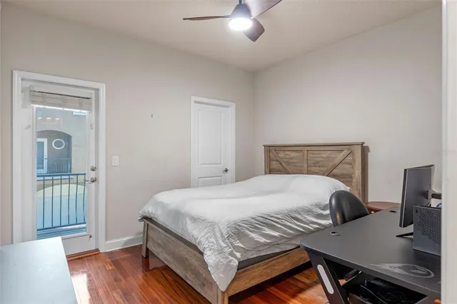 a bedroom with a bed and wooden floor
