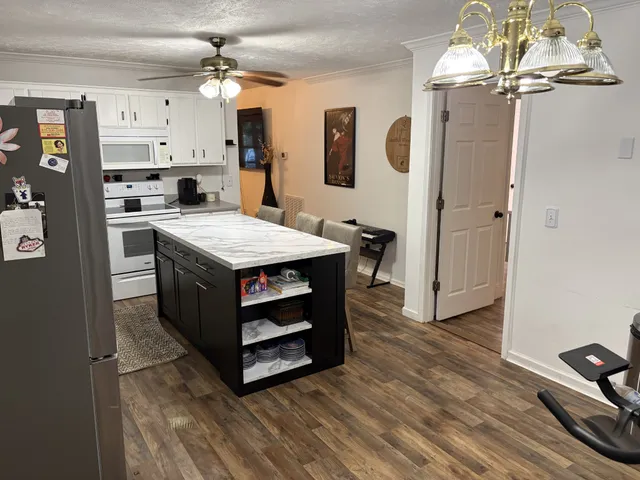 a kitchen that has a lot of cabinets in it