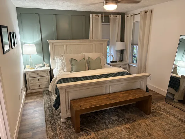 a bedroom with a bed and a chandelier