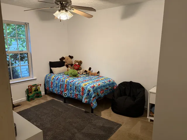 a bedroom with a bed and window