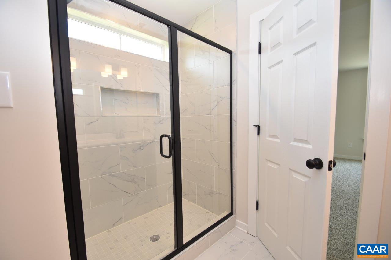 3124 Carysbrook Road, Unit CBE1 Palmyra, VA 22963 - Photo 32 of 32 a bathroom with a glass shower door