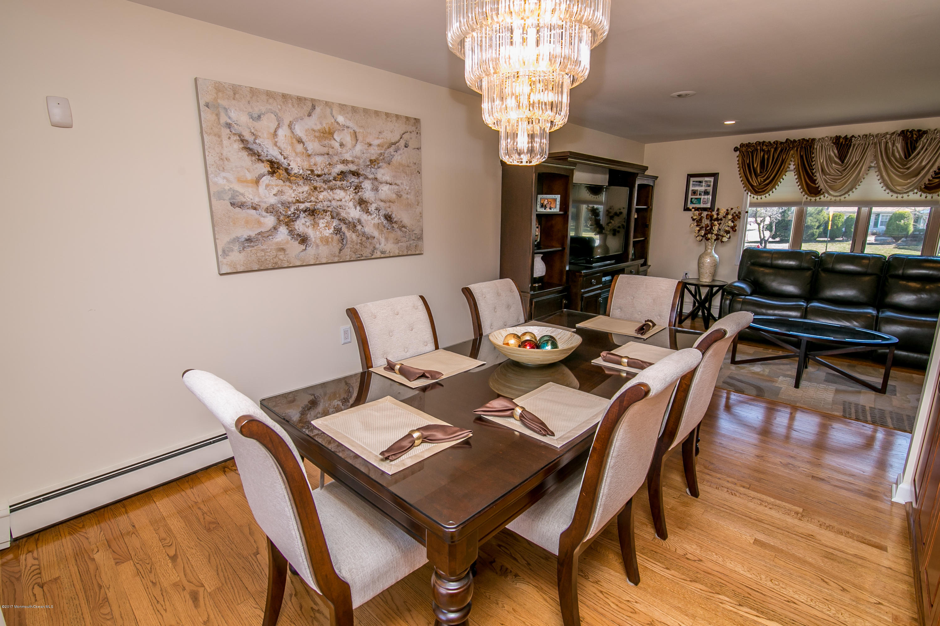 473 Lloyd Road Aberdeen, NJ 07747 - Photo 12 of 34 a view of a dining room with furniture a chandelier and wooden floor
