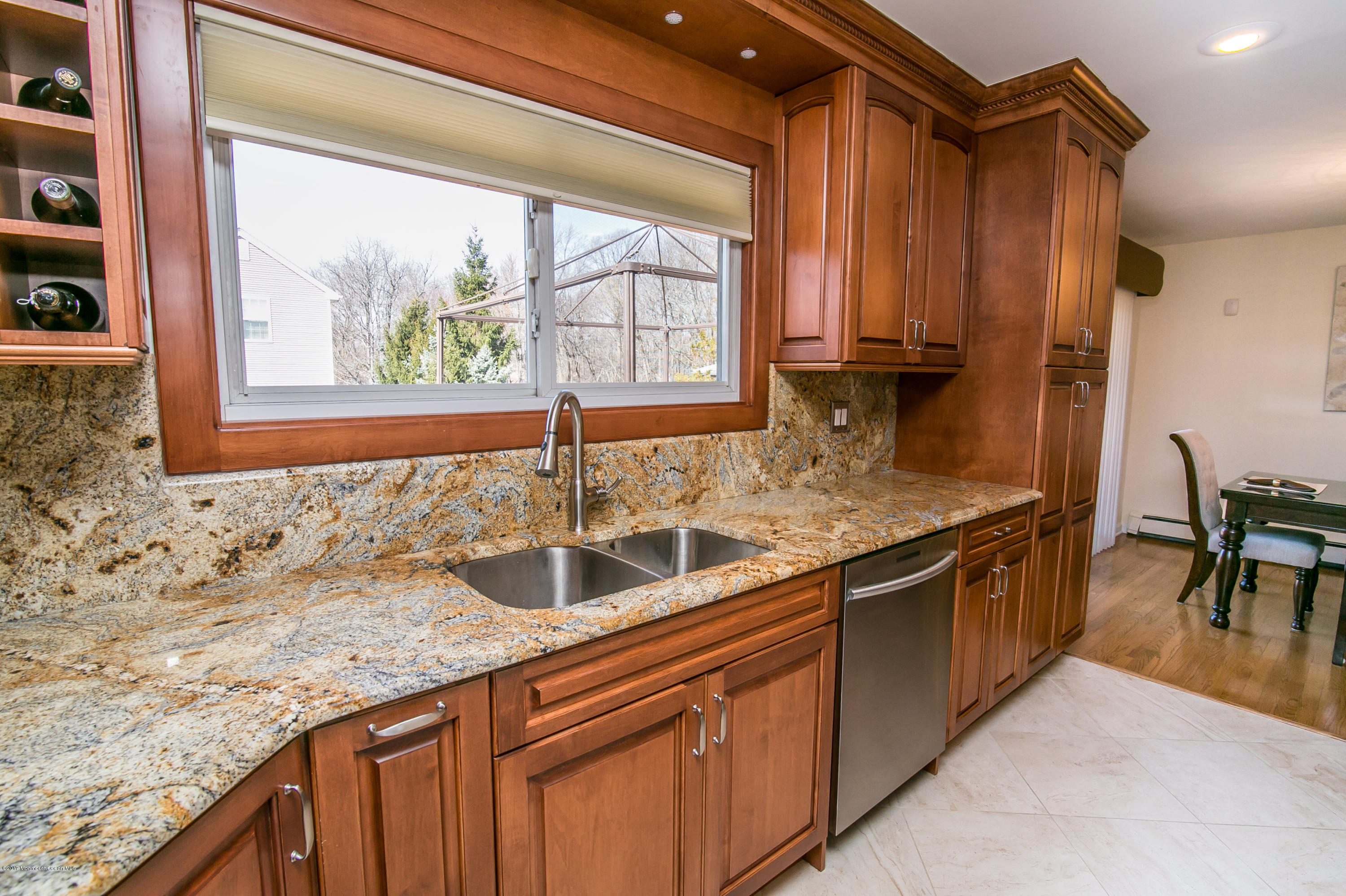 473 Lloyd Road Aberdeen, NJ 07747 - Photo 15 of 34 a kitchen with stainless steel appliances granite countertop a sink and a wooden cabinets