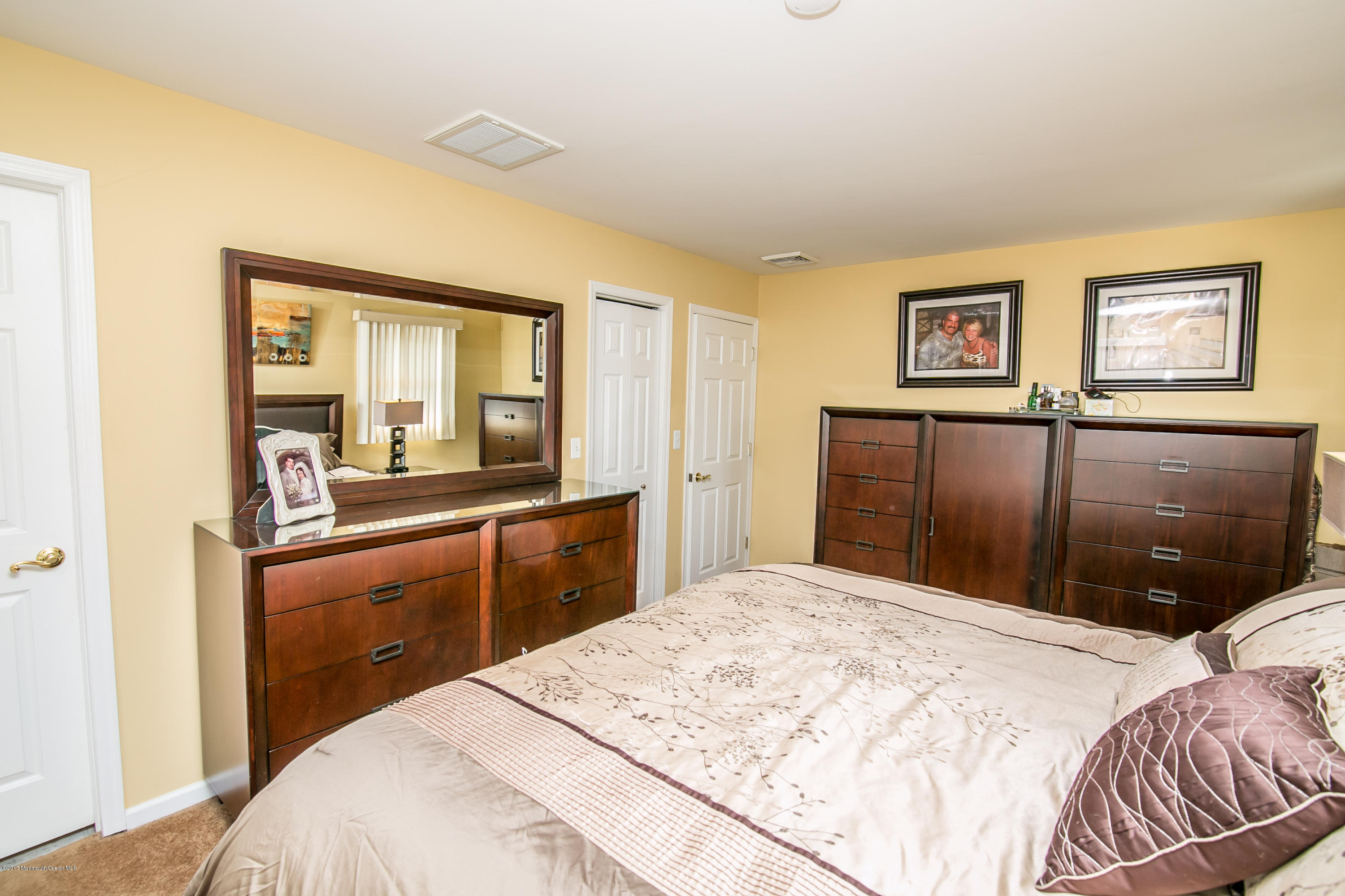 473 Lloyd Road Aberdeen, NJ 07747 - Photo 18 of 34 a bedroom with a bed and a large mirror on the dresser