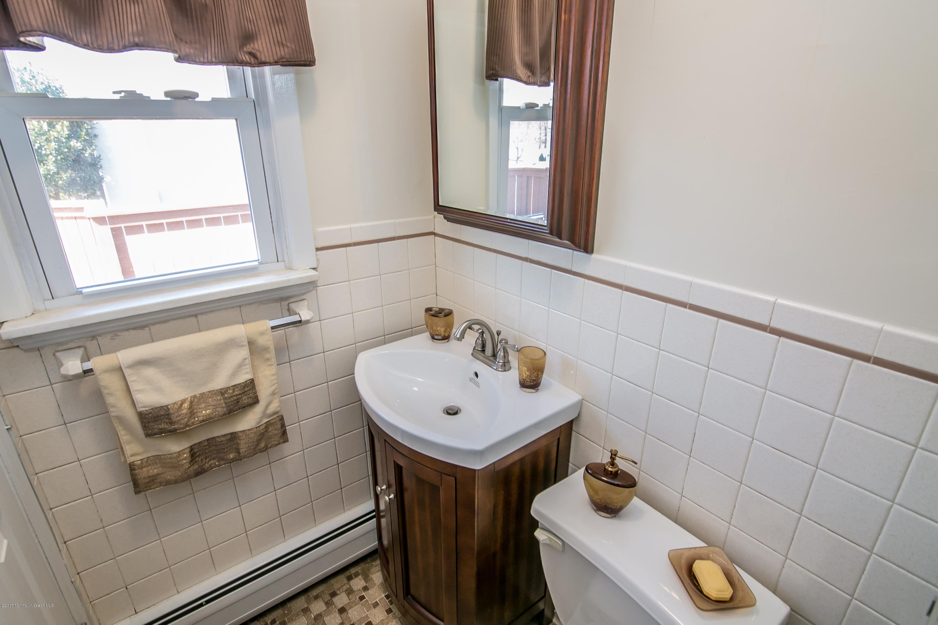 473 Lloyd Road Aberdeen, NJ 07747 - Photo 19 of 34 a bathroom with a sink and a window