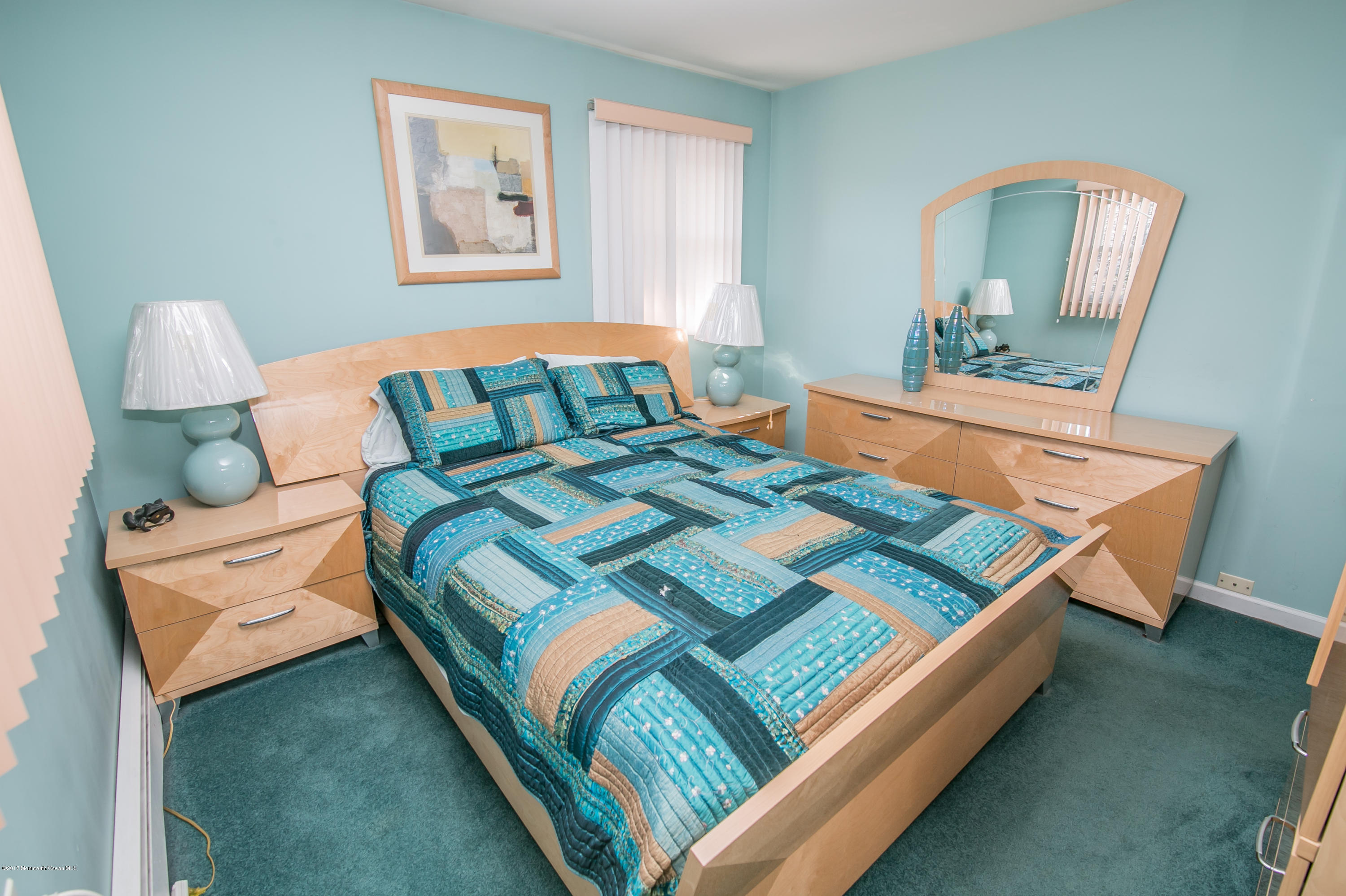 473 Lloyd Road Aberdeen, NJ 07747 - Photo 20 of 34 a bedroom with a bed lamp and a window