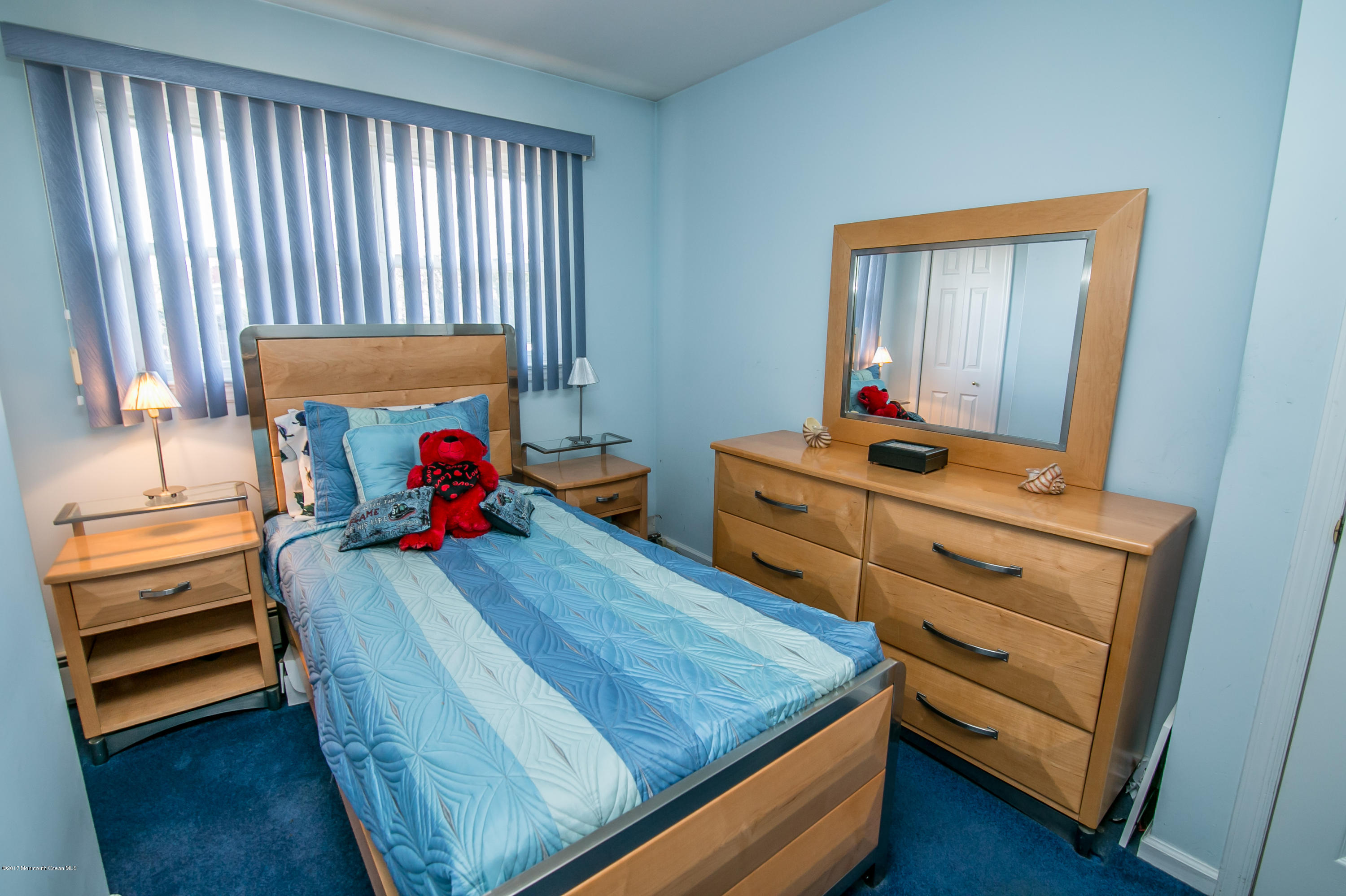 473 Lloyd Road Aberdeen, NJ 07747 - Photo 22 of 34 a bed room with a bed and a dresser