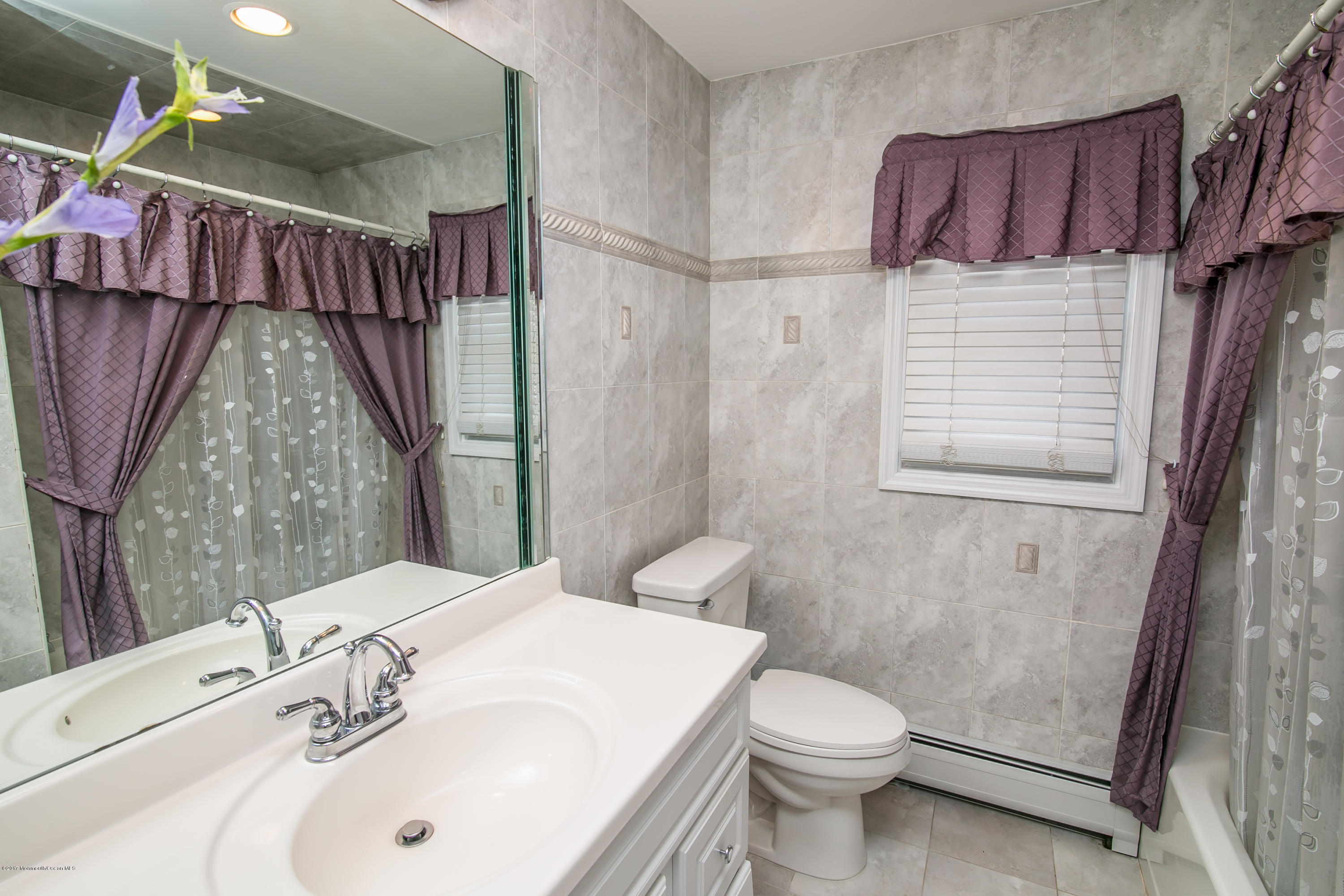 473 Lloyd Road Aberdeen, NJ 07747 - Photo 23 of 34 a bathroom with a sink a toilet and shower