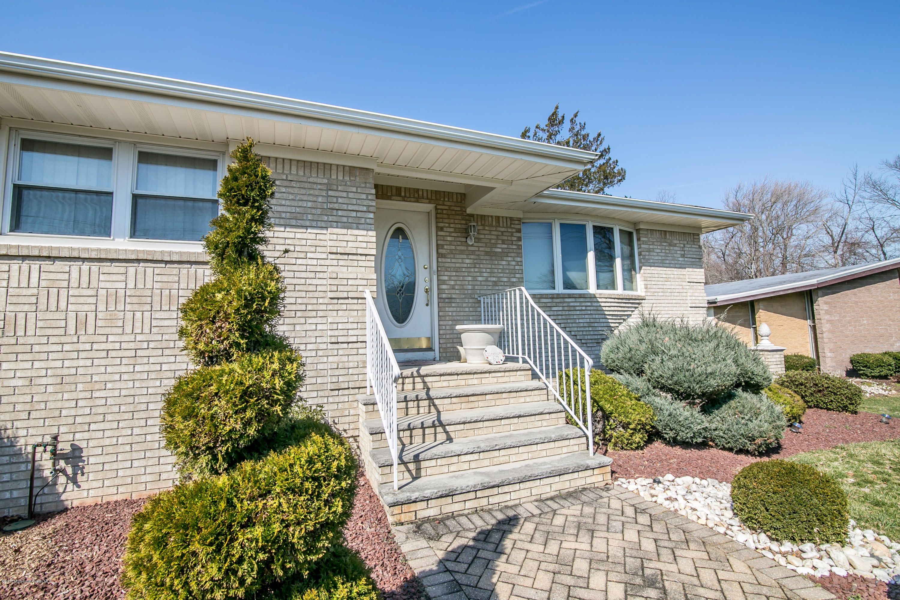 473 Lloyd Road Aberdeen, NJ 07747 - Photo 3 of 34 a front view of a house with a garden