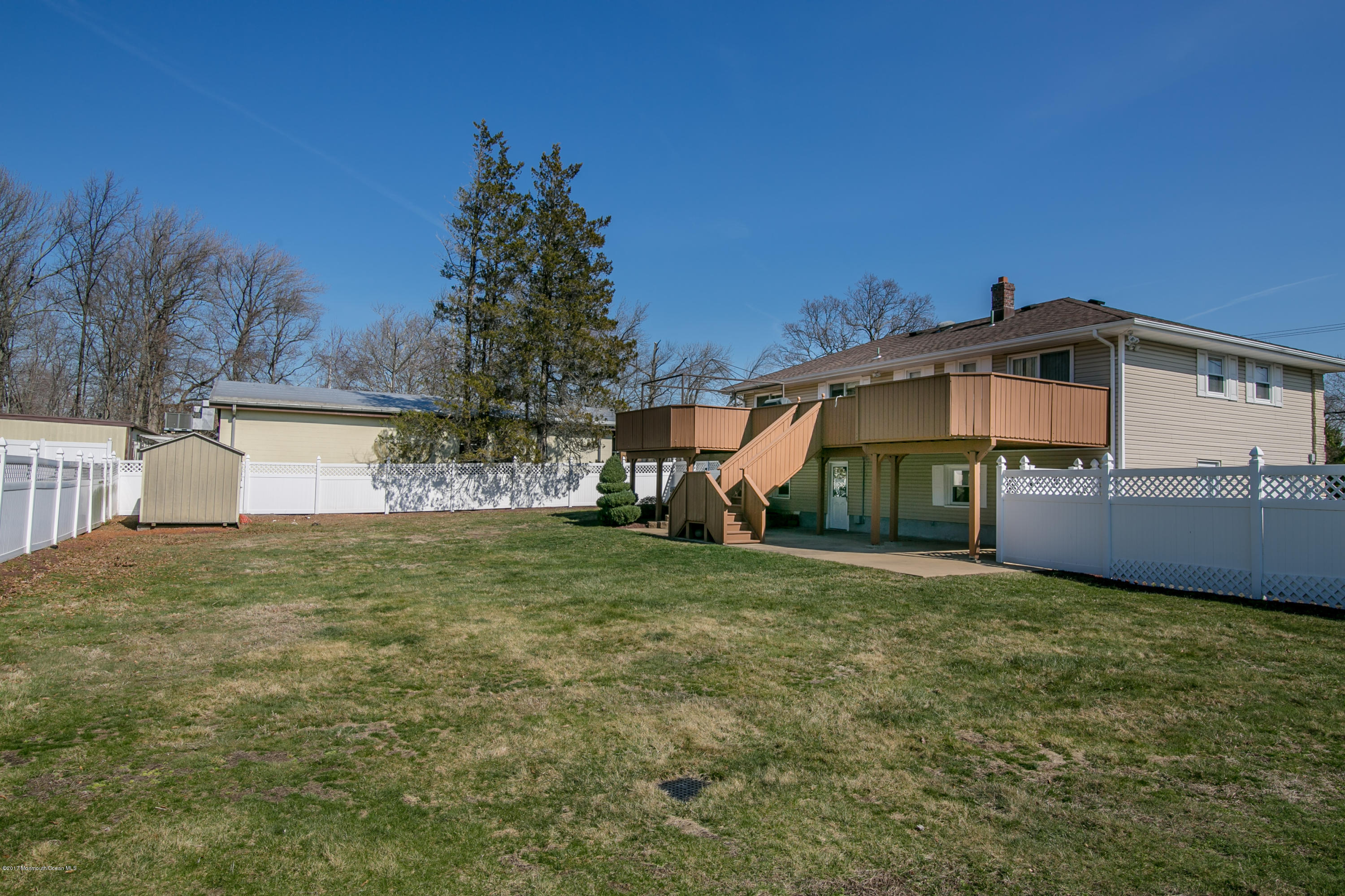 473 Lloyd Road Aberdeen, NJ 07747 - Photo 32 of 34 a front view of a house with a yard and garage