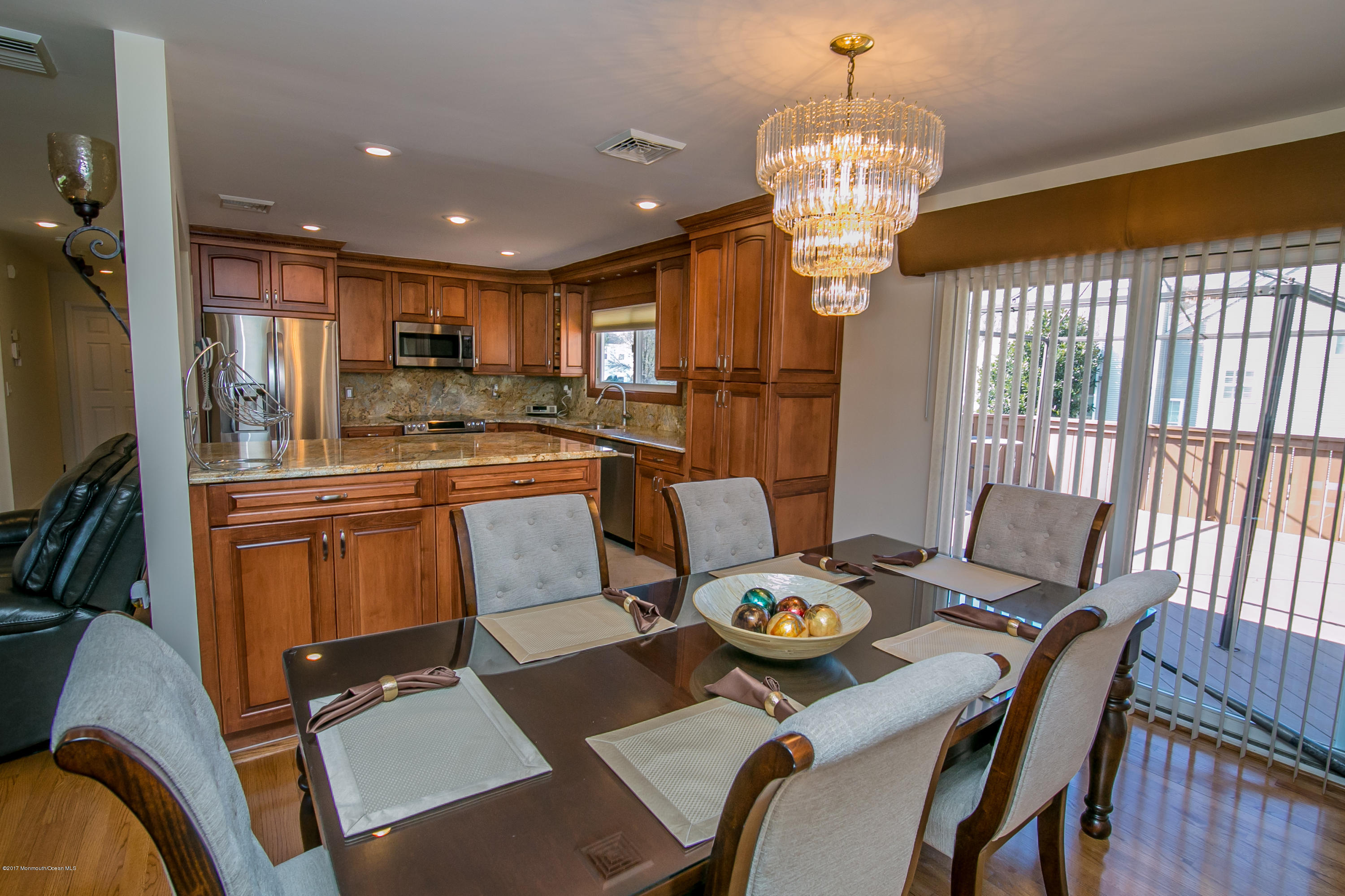 473 Lloyd Road Aberdeen, NJ 07747 - Photo 9 of 34 a kitchen with a dining table chairs stove and refrigerator