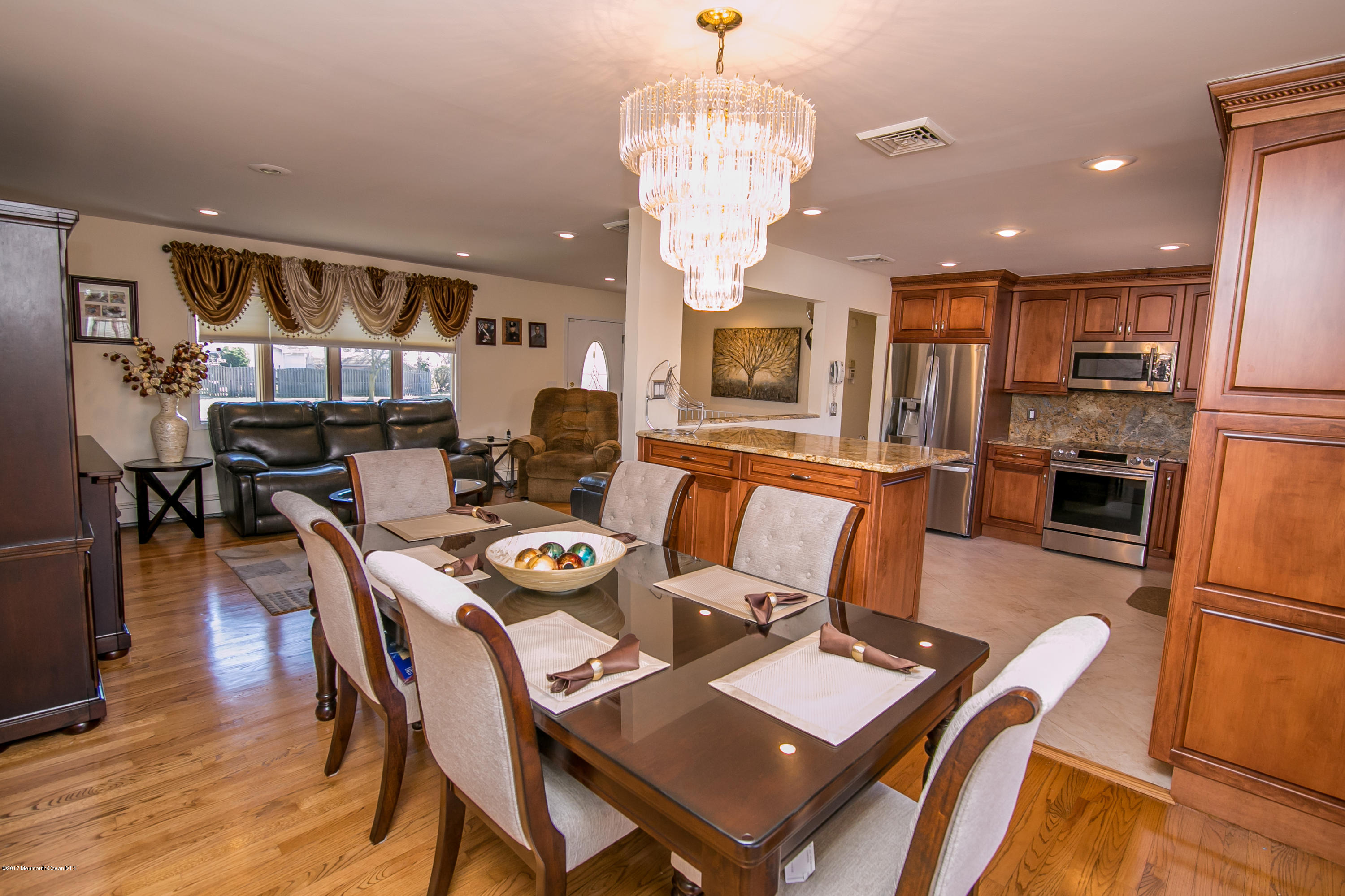 473 Lloyd Road Aberdeen, NJ 07747 - Photo 10 of 34 a dining room with furniture a kitchen and chandelier