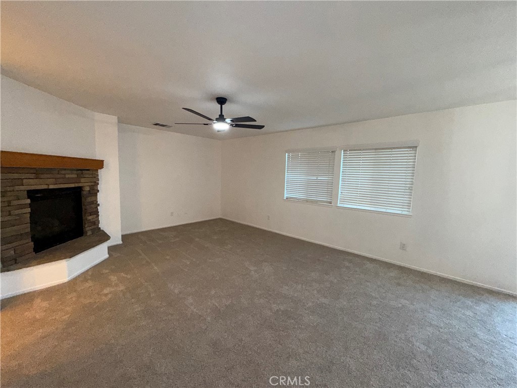29162 Hydrangea Street Murrieta, CA 92563 - Photo 11 of 46 a view of an empty room with a fireplace and a window