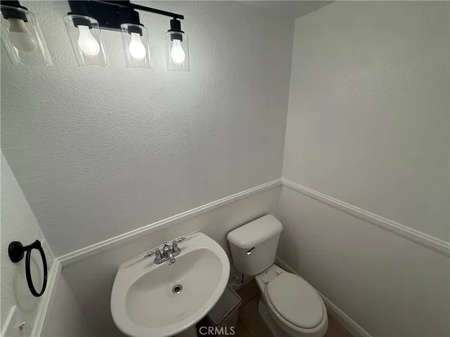 a white toilet sitting next to a white sink