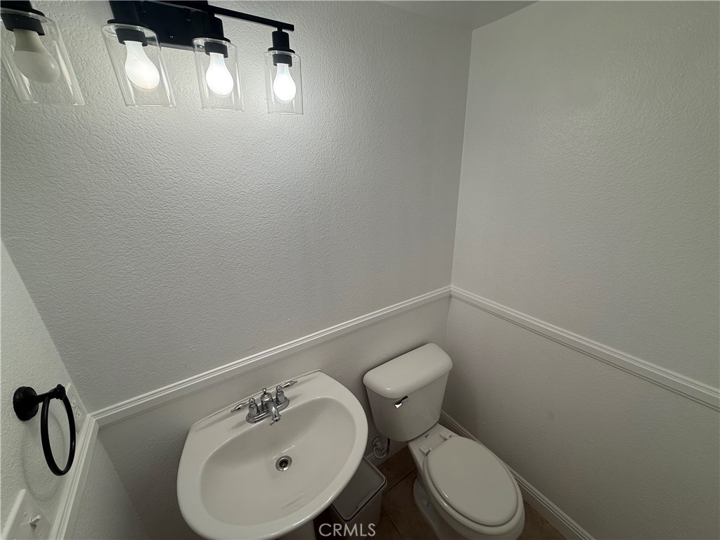 29162 Hydrangea Street Murrieta, CA 92563 - Photo 17 of 46 a white toilet sitting next to a white sink