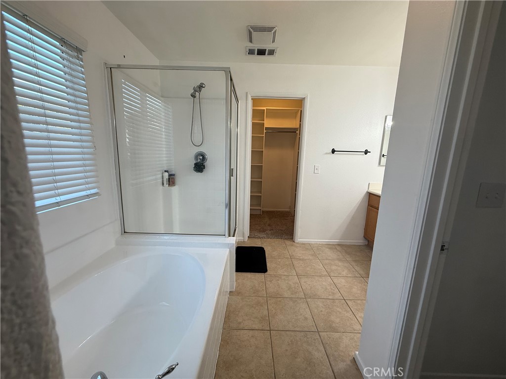 29162 Hydrangea Street Murrieta, CA 92563 - Photo 27 of 46 a bathroom with a glass door shower
