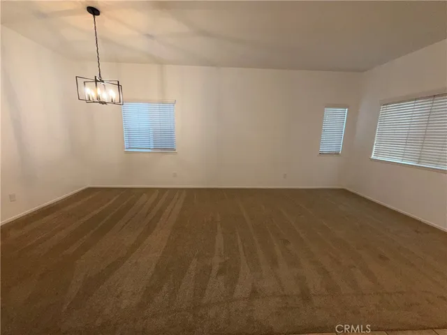 a view of a room with wooden floor and windows