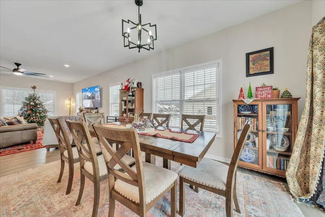 a view of a dining room with furniture and a chandelier
