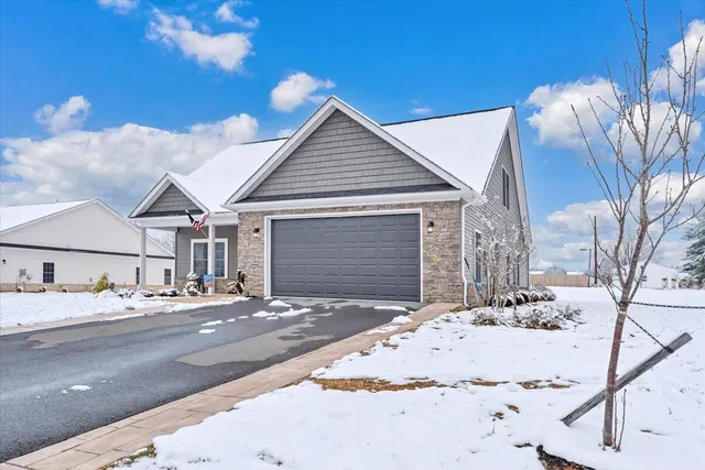 a view of a house with snow on the road