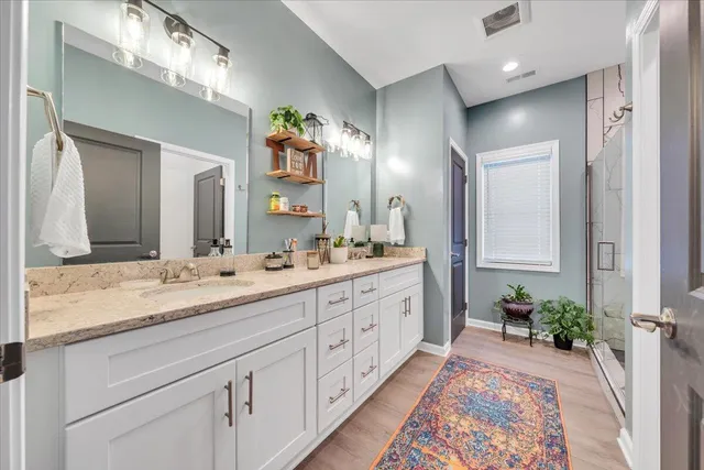 a spacious bathroom with a double vanity sink and a mirror
