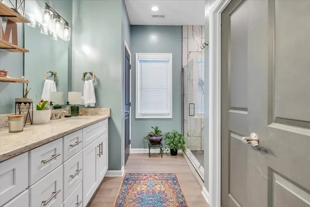 a spacious bathroom with a double vanity sink and a mirror