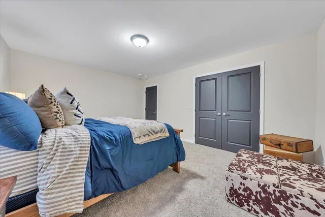 a bedroom with a large bed and a closet