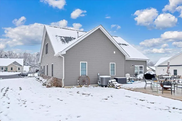 a view of a dinning table and chairs in the patio of the house