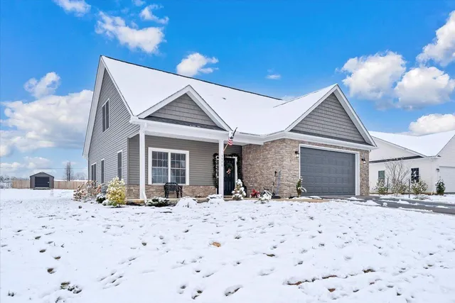 a view of a house with snow on the side of the road